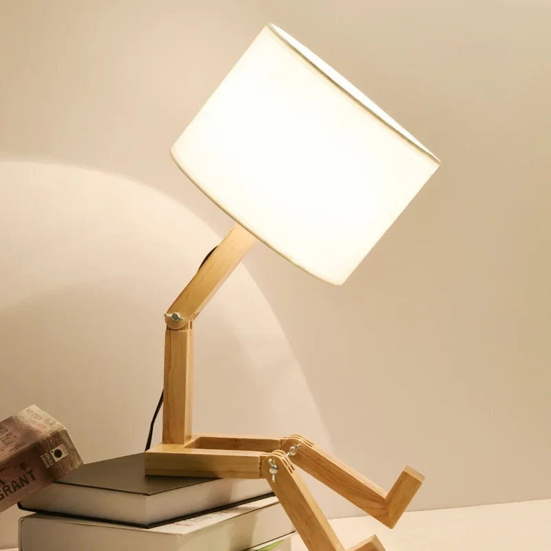 Illuminate your space with our Adjusted Robot Shape Table Lamp! This unique E27 lamp features a wooden and fabric design, perfect for bedrooms or study rooms. Its foldable structure offers versatility for any setting. Enhance your decor today!