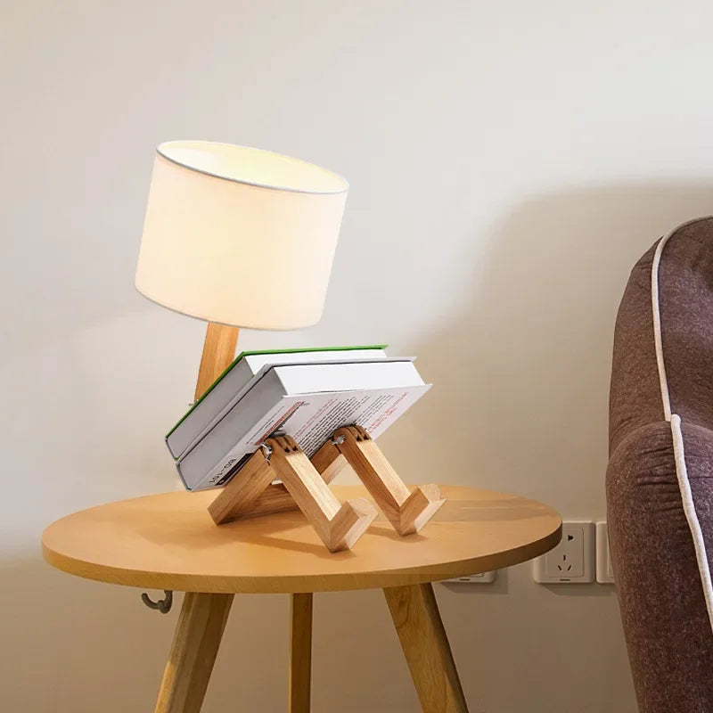 Illuminate your space with our Adjusted Robot Shape Table Lamp! This unique E27 lamp features a wooden and fabric design, perfect for bedrooms or study rooms. Its foldable structure offers versatility for any setting. Enhance your decor today!