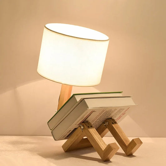 Illuminate your space with our Adjusted Robot Shape Table Lamp! This unique E27 lamp features a wooden and fabric design, perfect for bedrooms or study rooms. Its foldable structure offers versatility for any setting. Enhance your decor today!