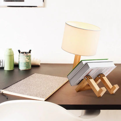 Illuminate your space with our Adjusted Robot Shape Table Lamp! This unique E27 lamp features a wooden and fabric design, perfect for bedrooms or study rooms. Its foldable structure offers versatility for any setting. Enhance your decor today!